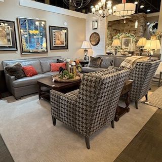 A living room filled with furniture including a couch and chairs