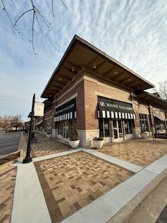 A large brick building with a black awning on the front of it