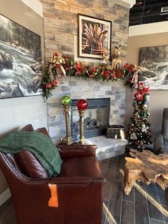 A living room with a fireplace and a christmas tree.