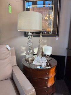 A lamp is sitting on a table next to a couch.