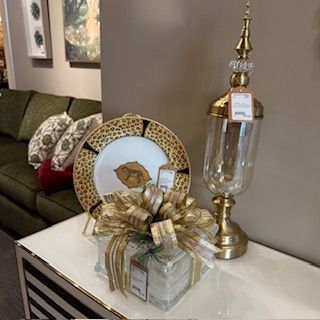 A table with a plate and a vase on it