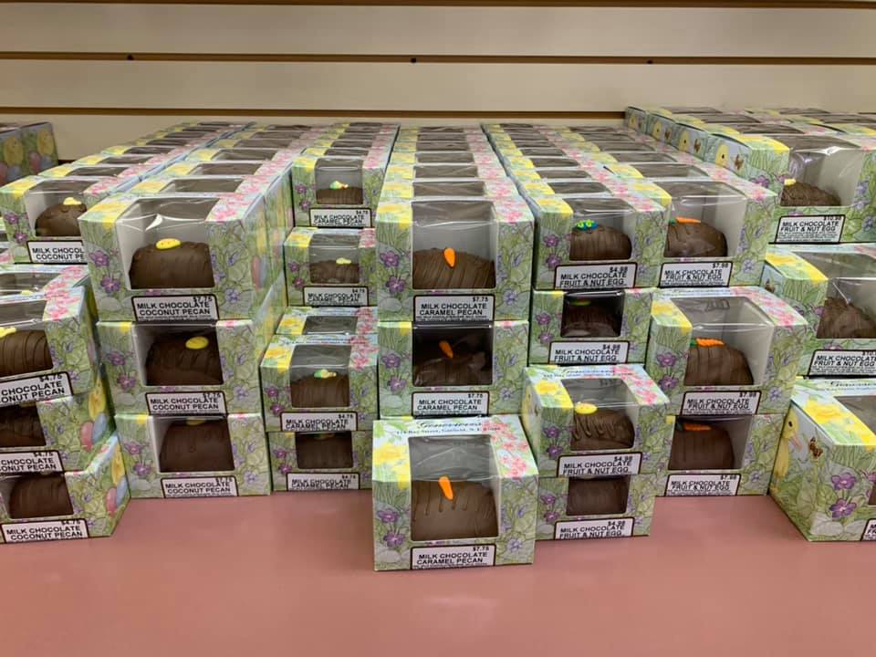 A bunch of chocolate eggs are stacked on top of each other on a table.