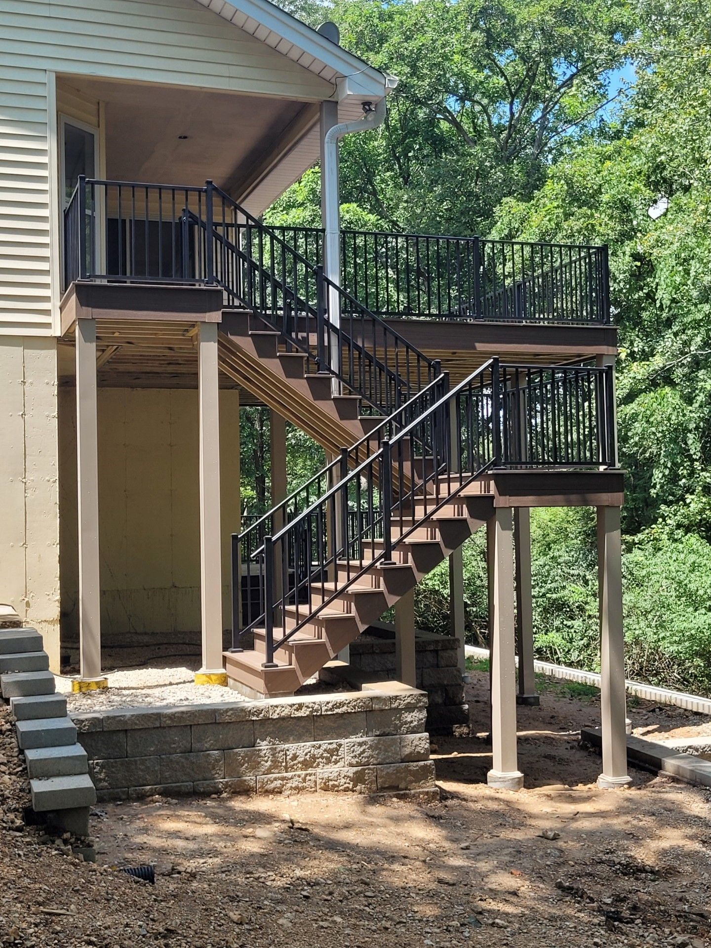 a house with a deck and stairs leading up to it