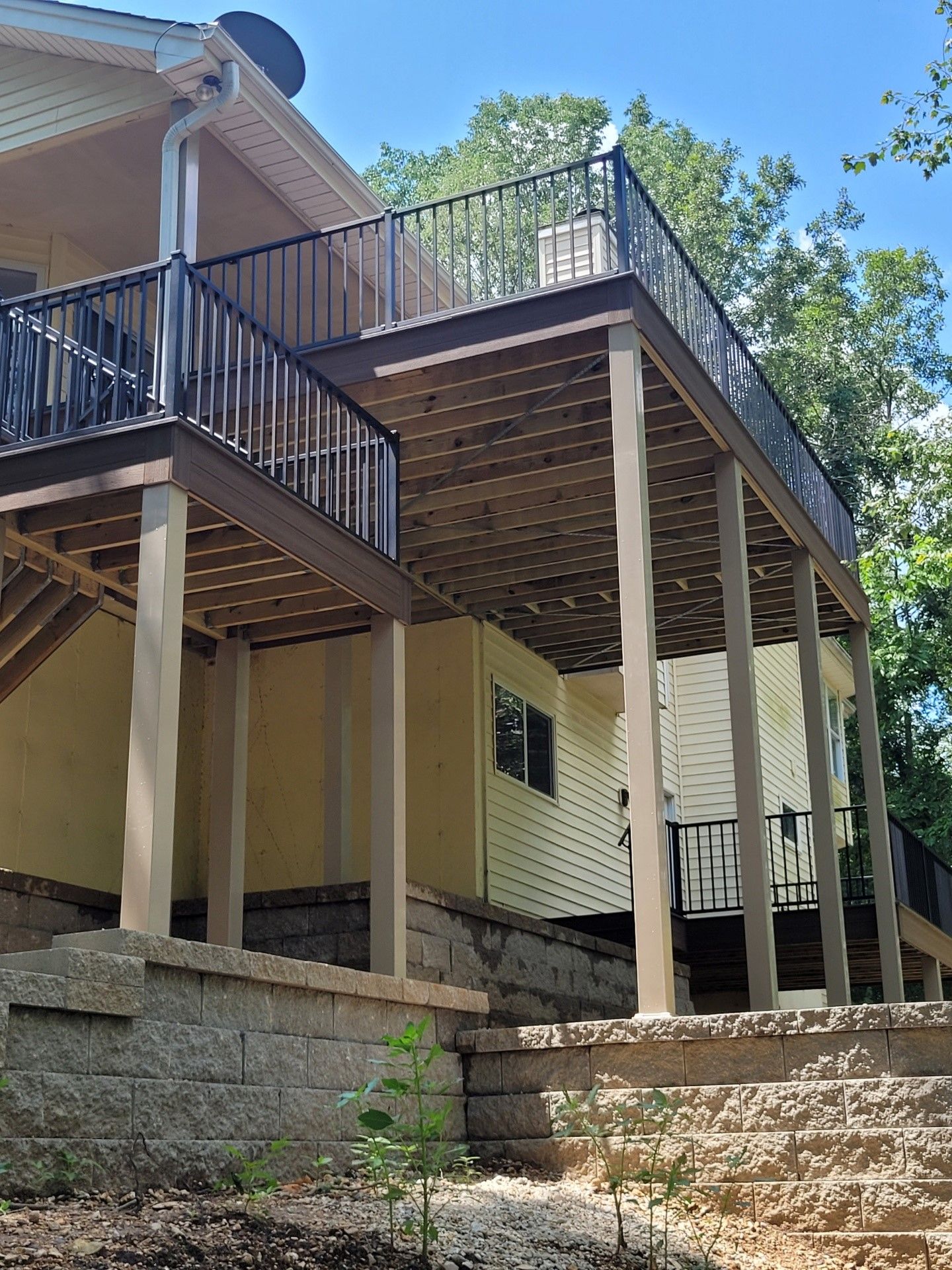 a house with a large deck and stairs leading up to it
