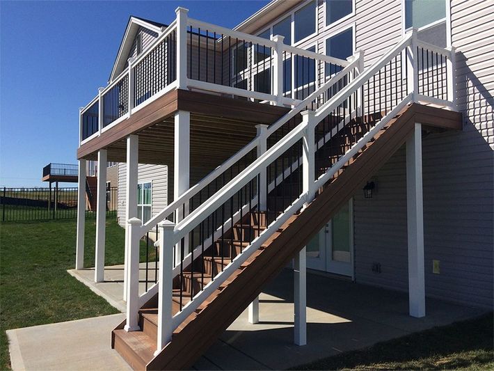 a house with a deck and stairs leading up to it
