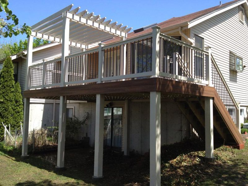a white house with a large deck and stairs