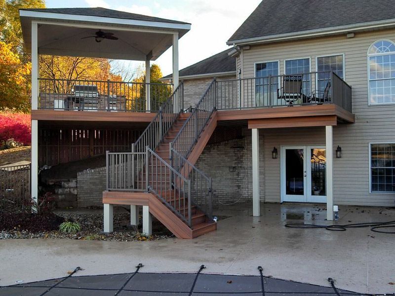 a house with a large deck and stairs leading up to it