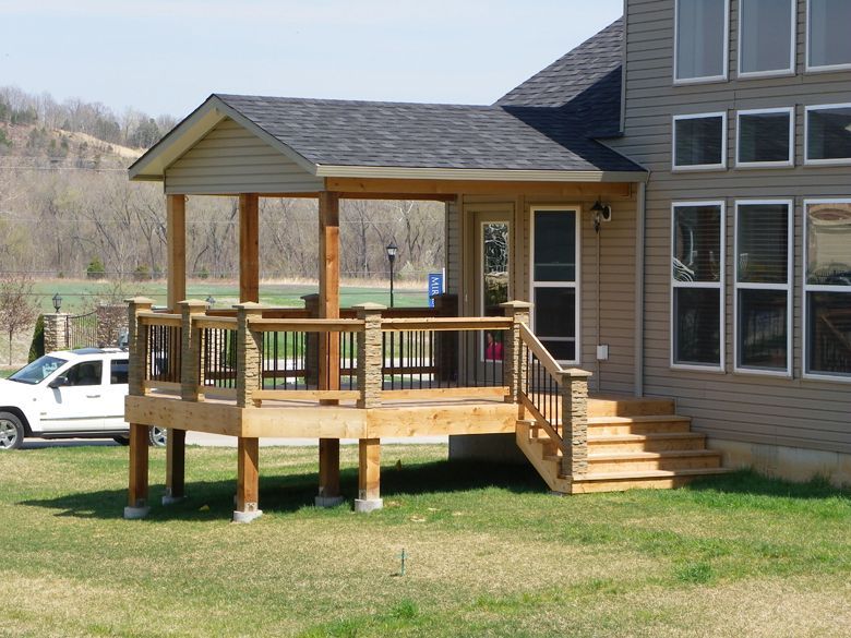 a house with a porch and stairs in front of it
