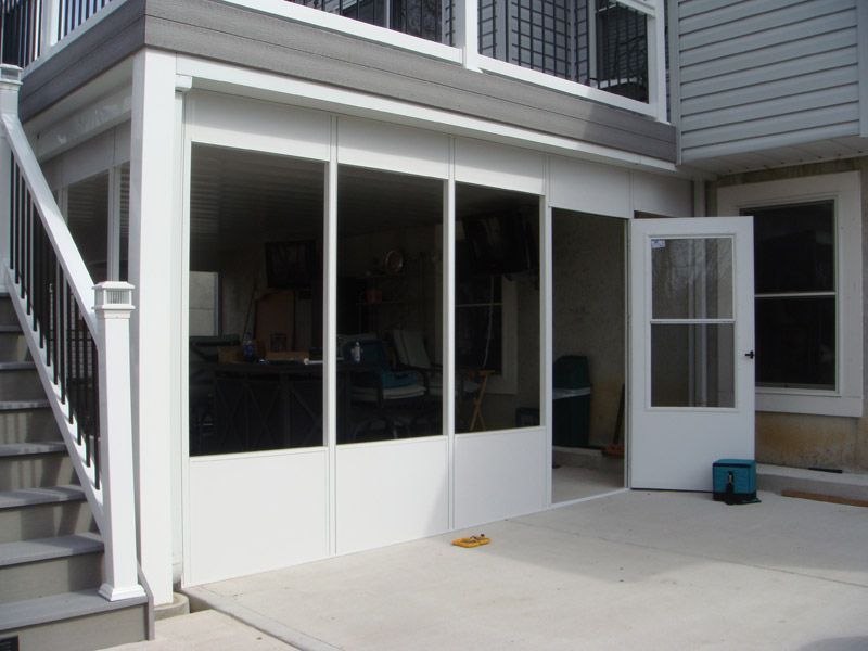 a screened porch with stairs leading up to it