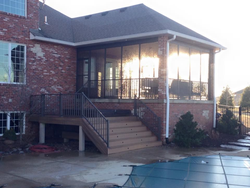 a screened porch with stairs leading up to it