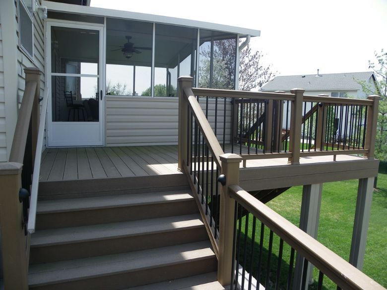 a deck with stairs leading up to a screened porch