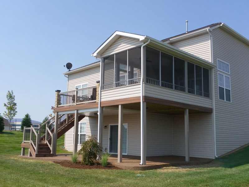 a house with a screened porch and stairs