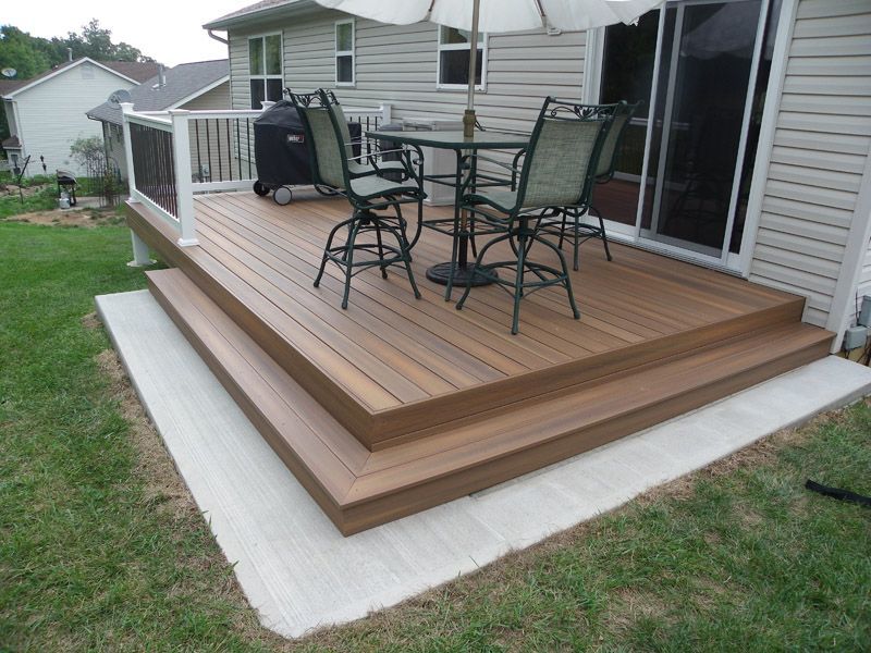 a wooden deck with a table and chairs on it