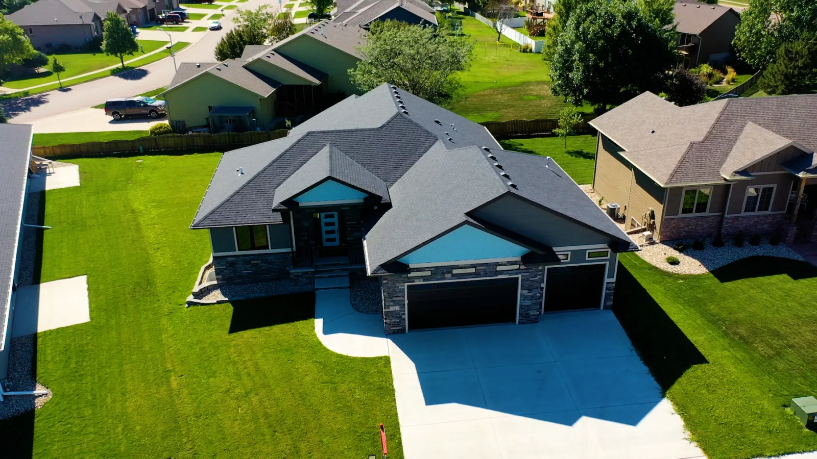 An aerial view of a house in a residential neighborhood.