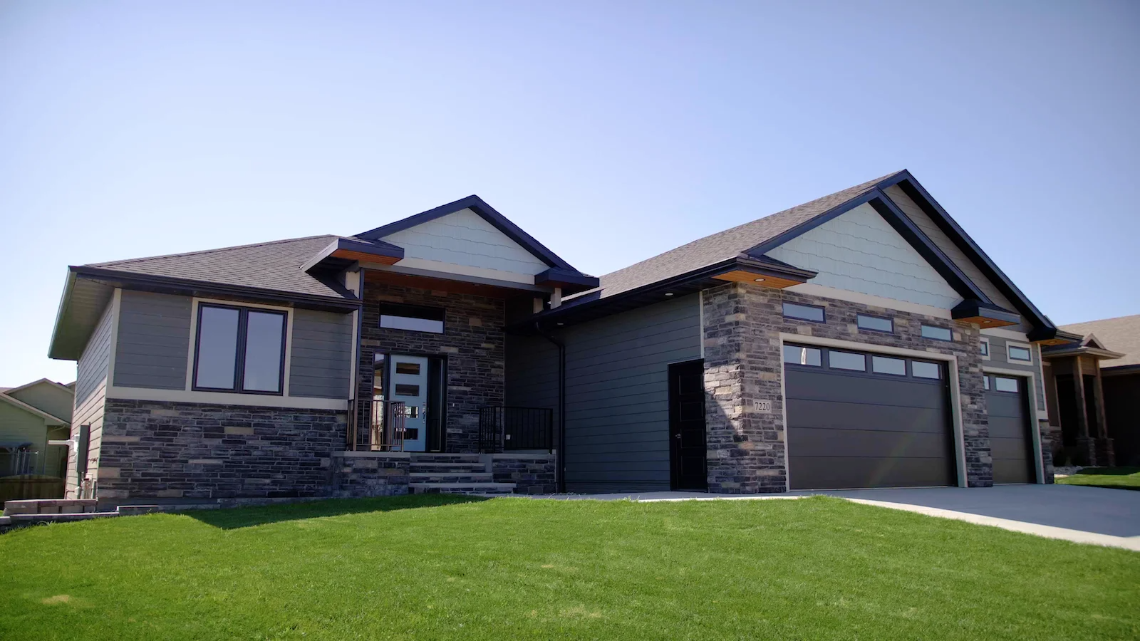 A large house with a large lawn in front of it