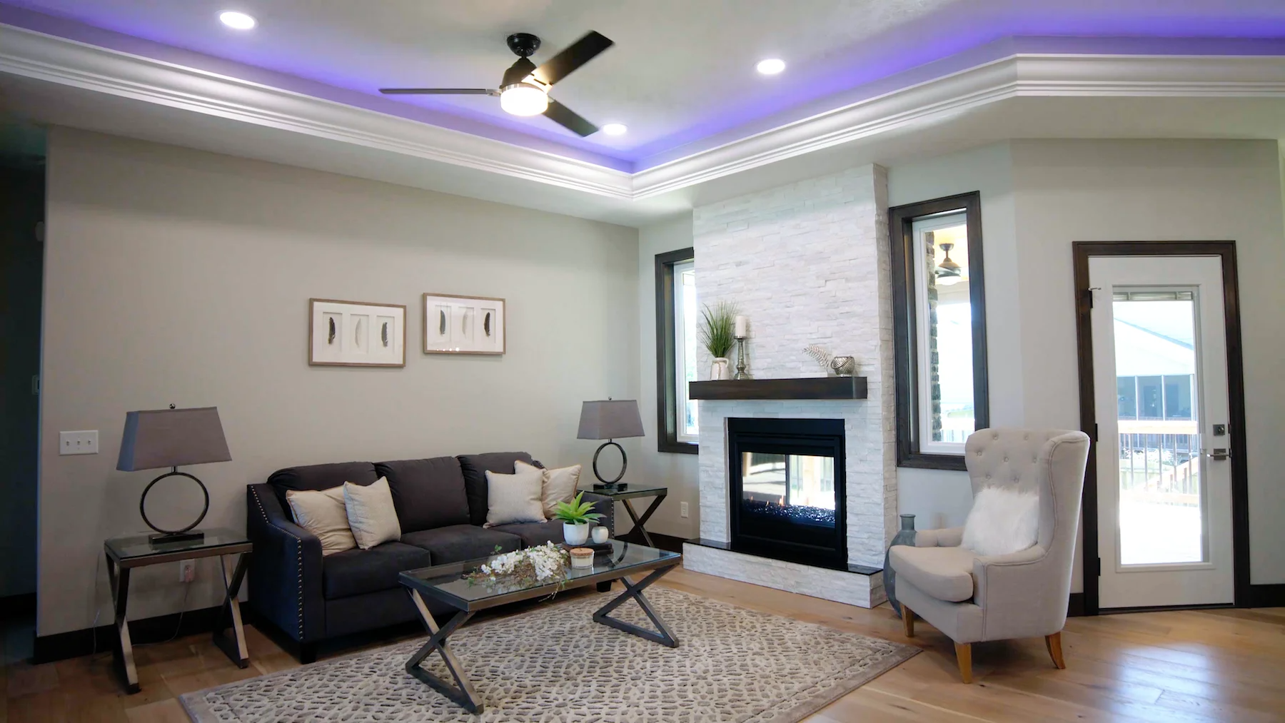 A living room with a couch , chair , coffee table and fireplace.