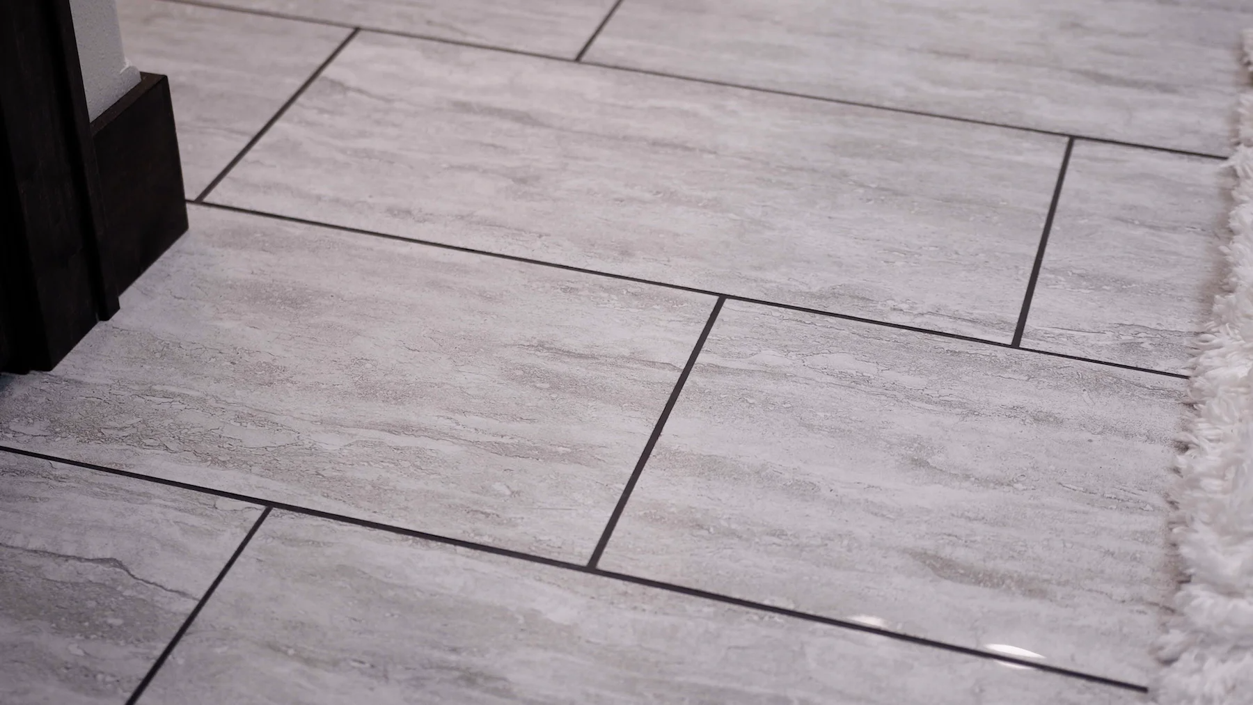A close up of a tiled floor in a bathroom.