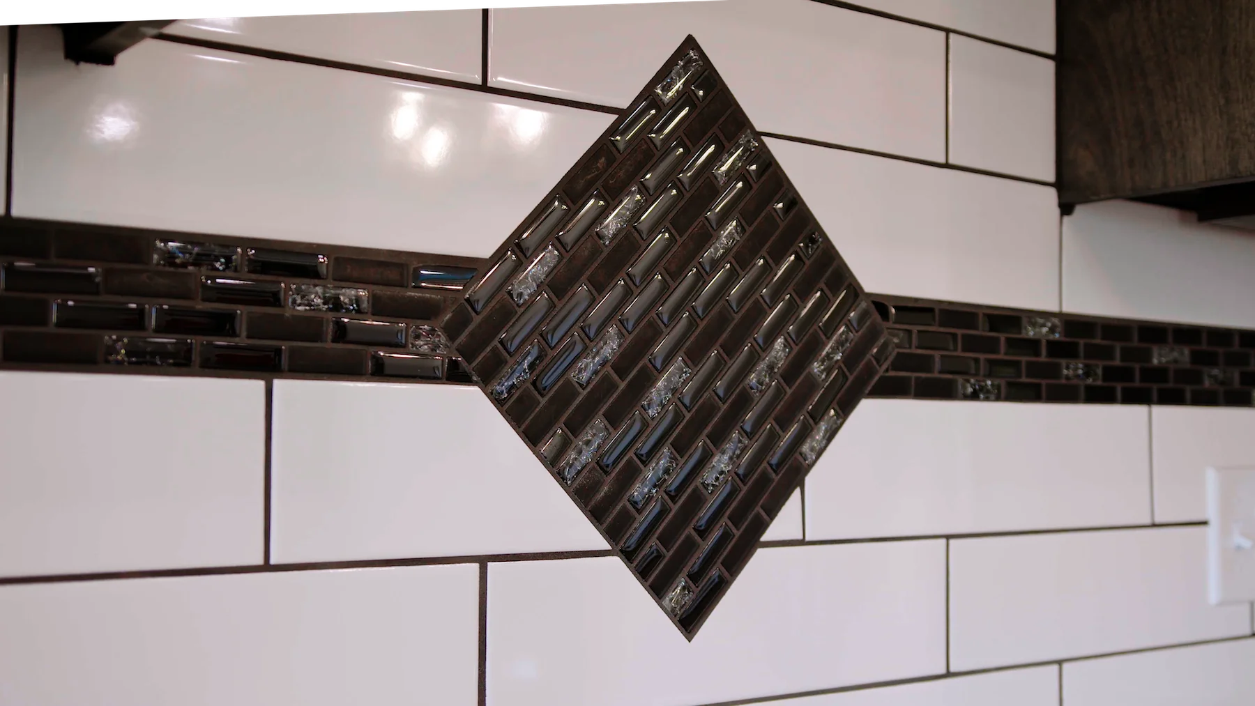 A black and white tile with a diamond in the middle