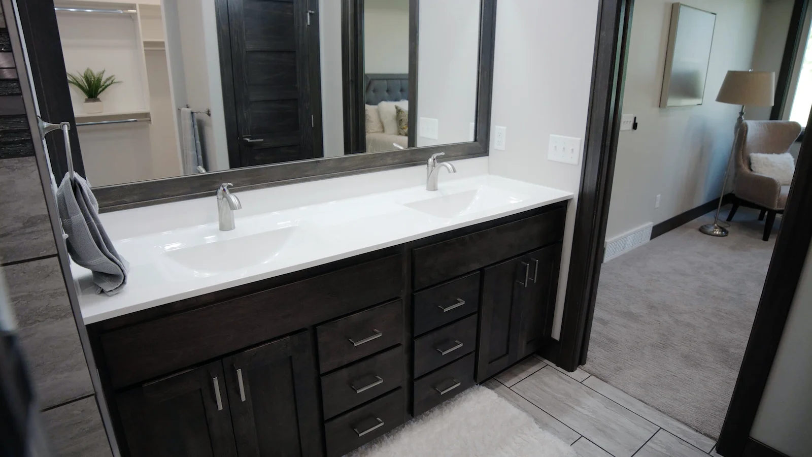 A bathroom with two sinks and a large mirror.