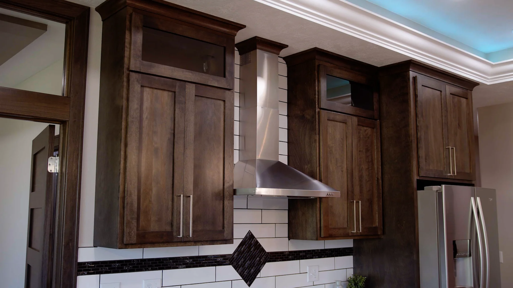 A kitchen with stainless steel appliances and wooden cabinets