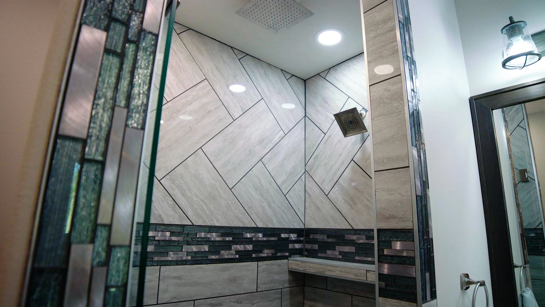 A bathroom with a walk in shower and a mirror.