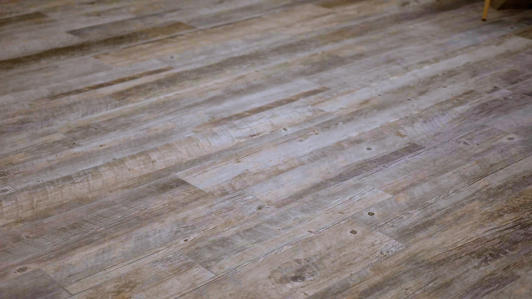 A close up of a wooden floor in a room.