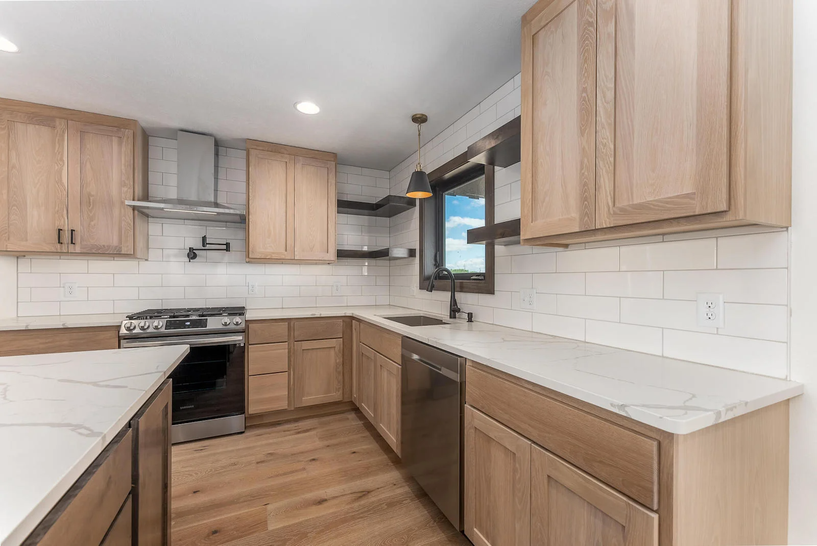 A kitchen with wooden cabinets and stainless steel appliances.