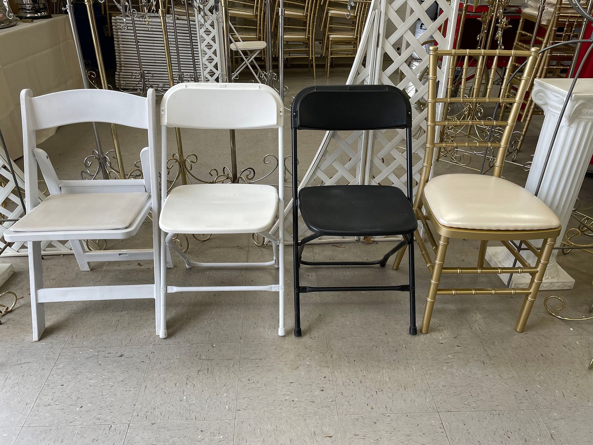 A row of folding chairs are lined up in a room
