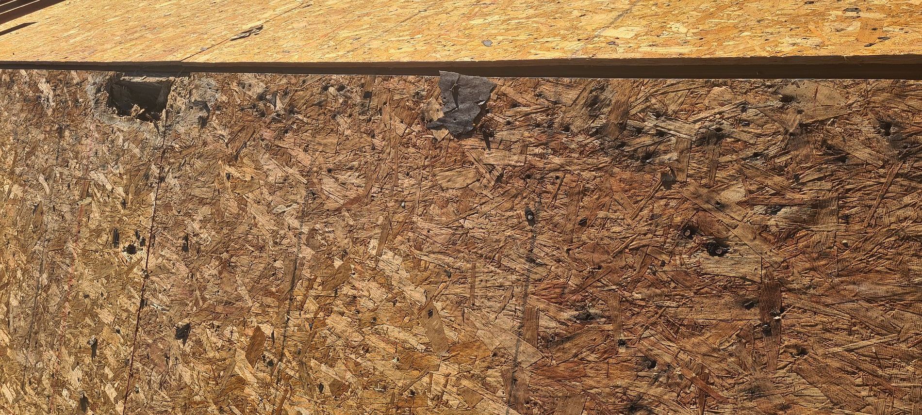 Close-up of brown speckled stone surface with a dark horizontal strip along the top