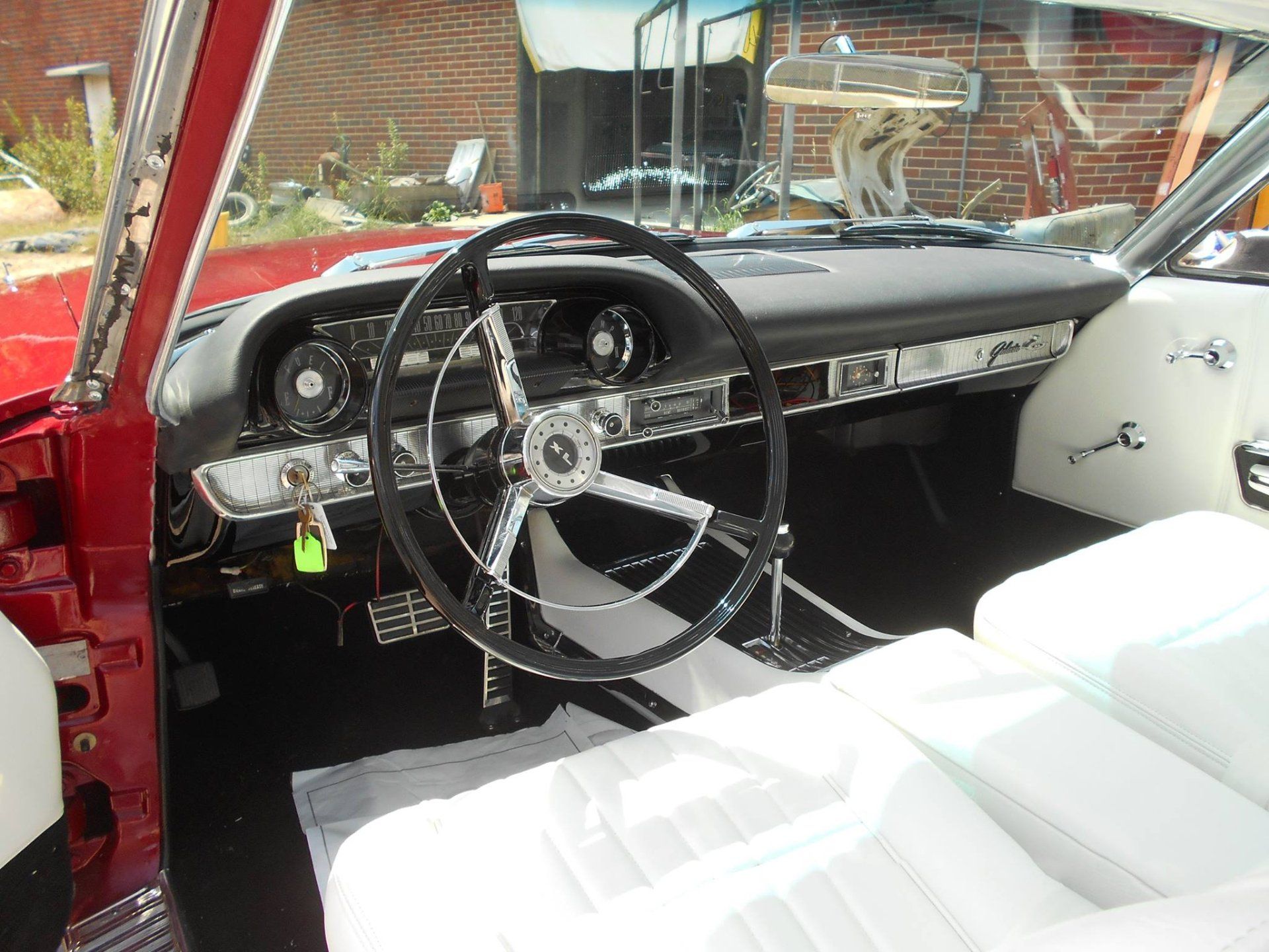 The inside of a red car with a steering wheel