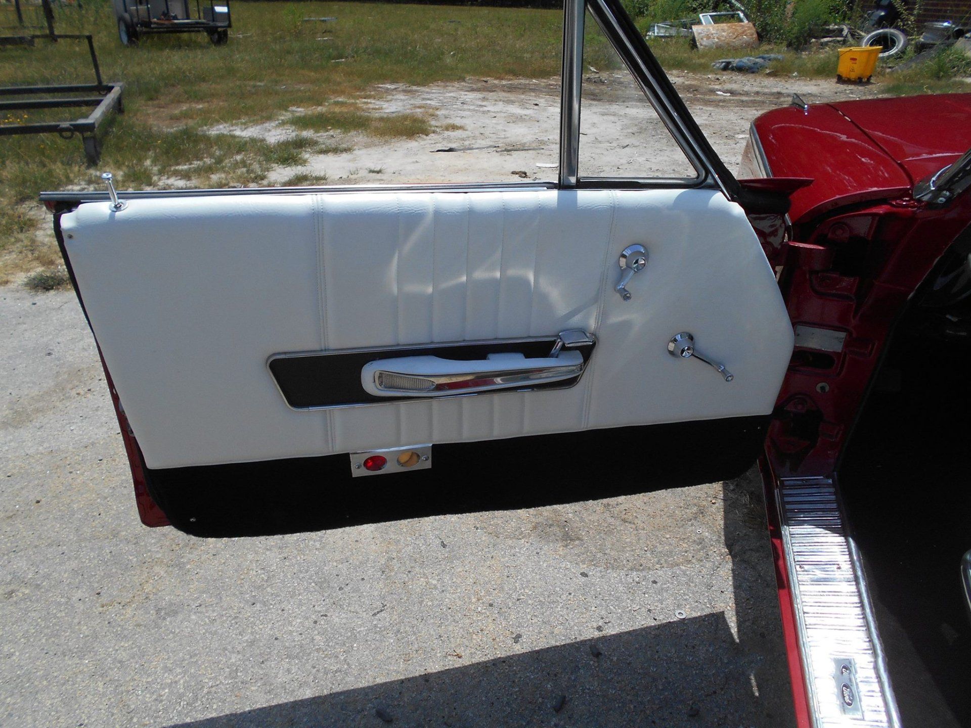 A red and white car with the door open