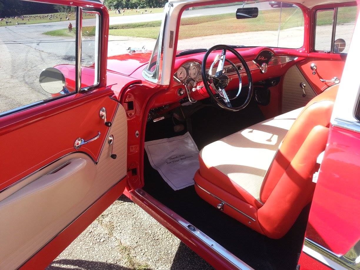 The inside of a red car with the door open