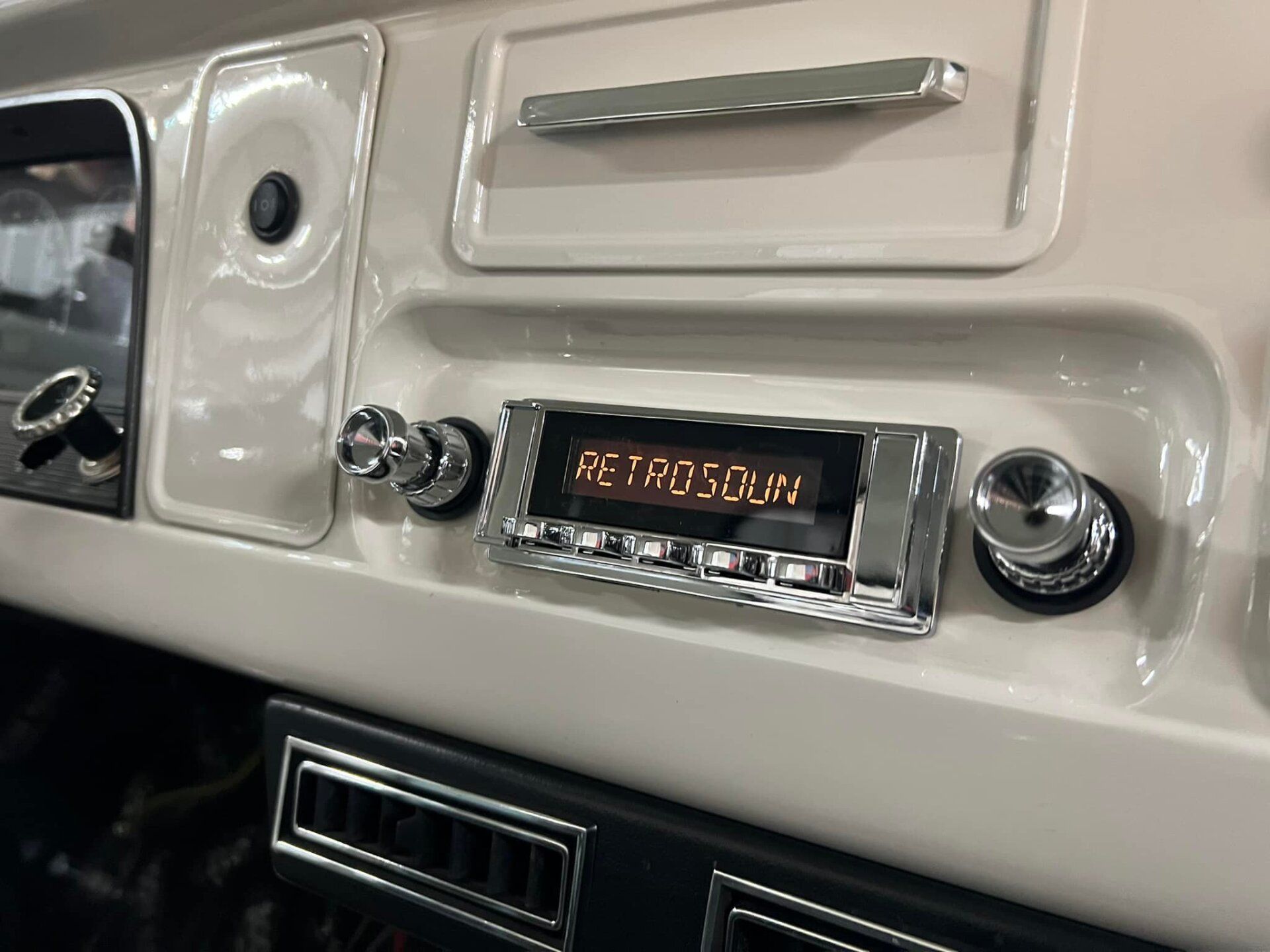 A car radio is sitting on the dashboard of a car.