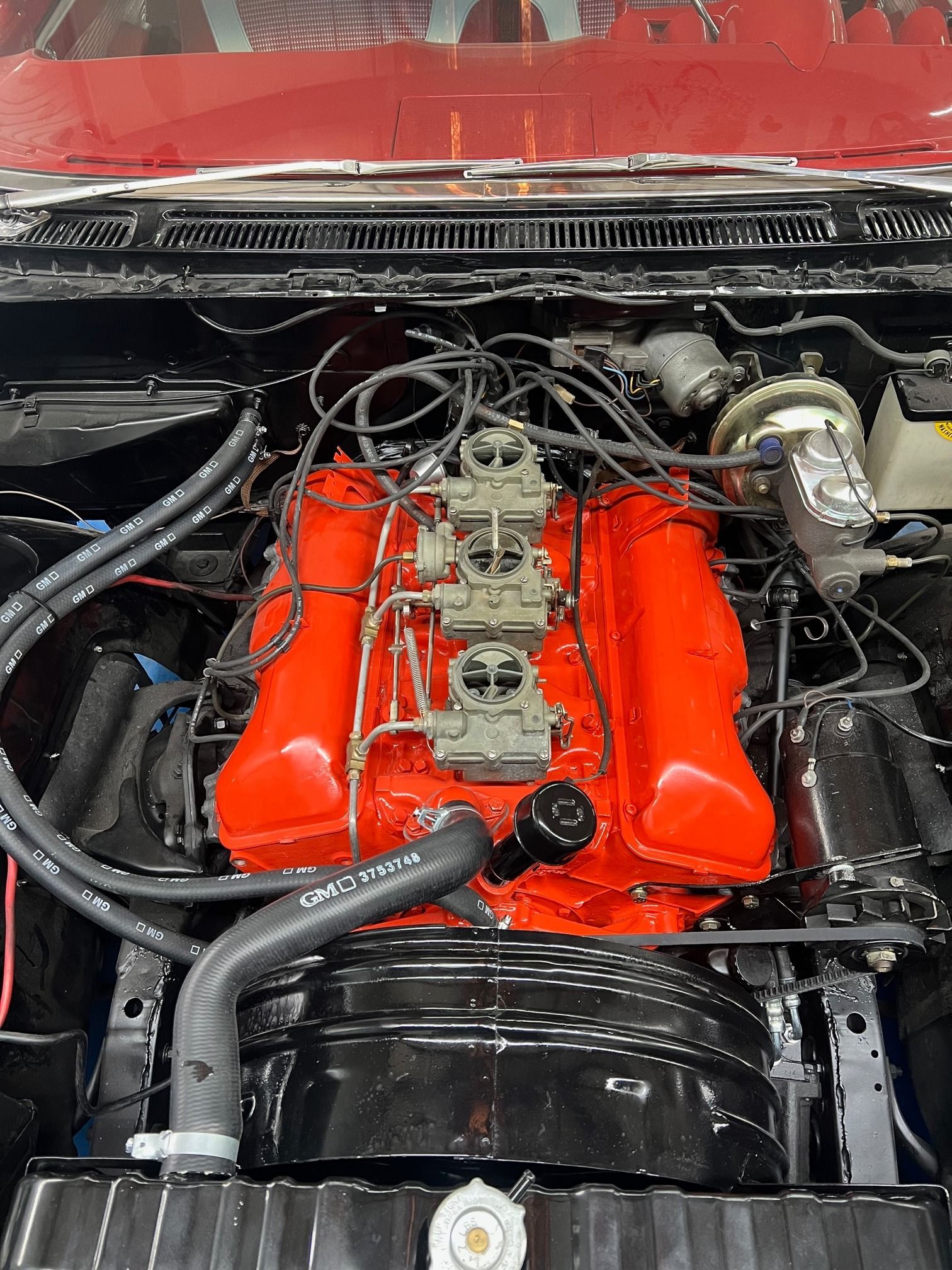 A close up of the engine of a red car.
