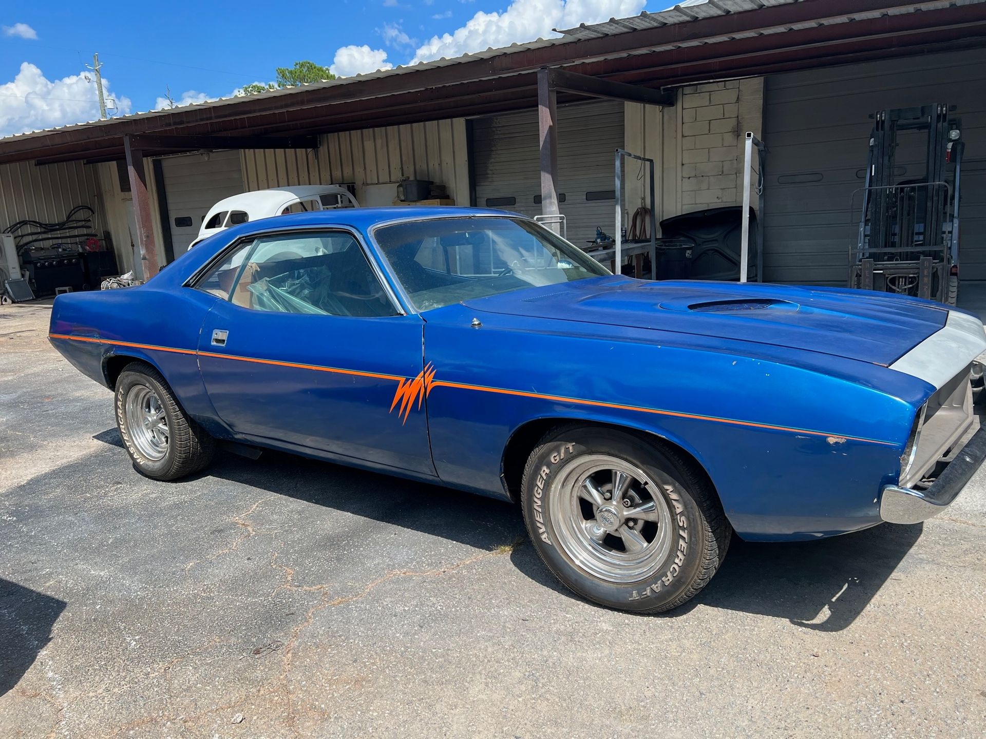 1973 Plymouth Barracuda is parked in a parking lot.
