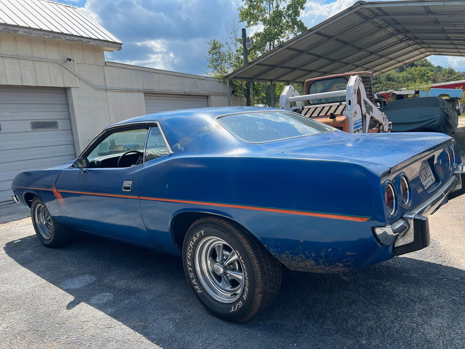 A 1973 Plymouth Barracuda, representing classic American muscle car design and heritage.