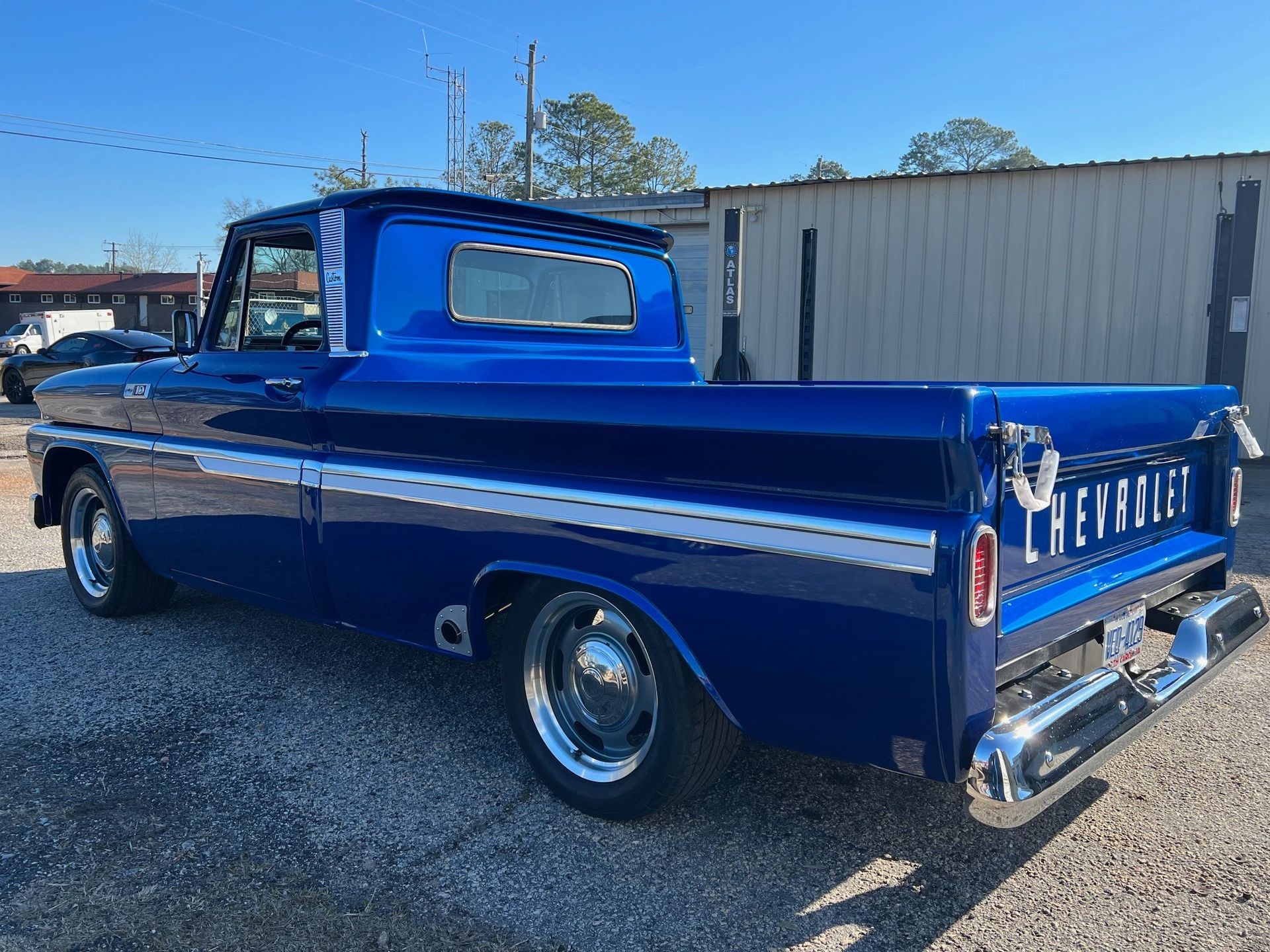 Blue classic Chevrolet pickup truck with white stripe, parked outside.