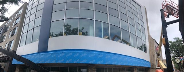 A large building with a blue awning on the side of it
