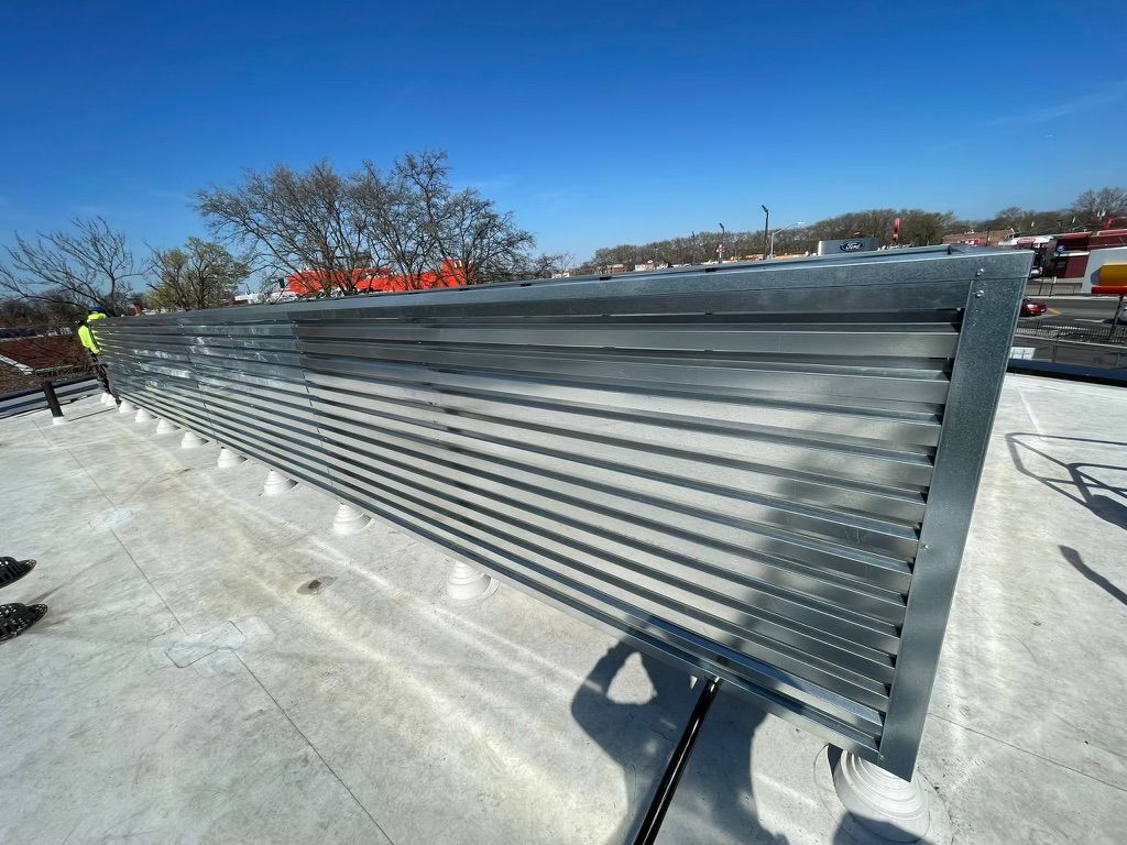 A metal fence with a blue sky in the background