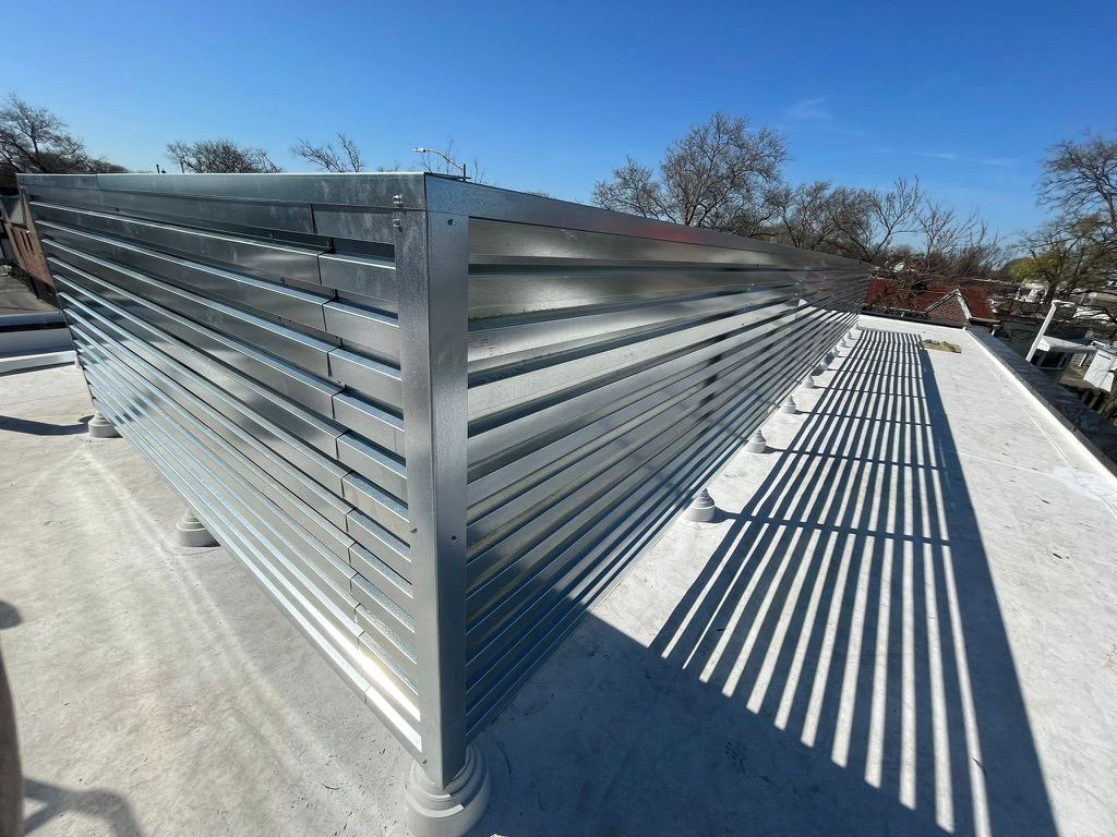 A metal fence is sitting on top of a concrete roof
