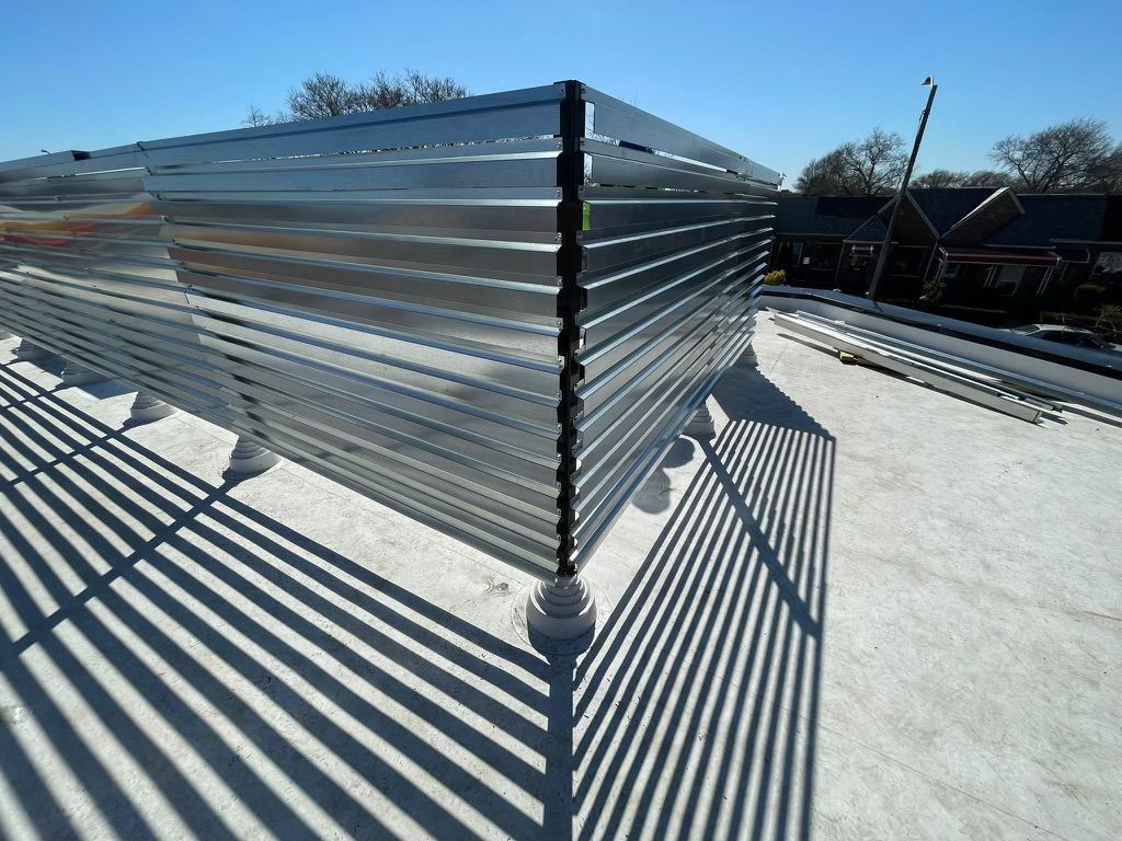 A metal fence on top of a white roof