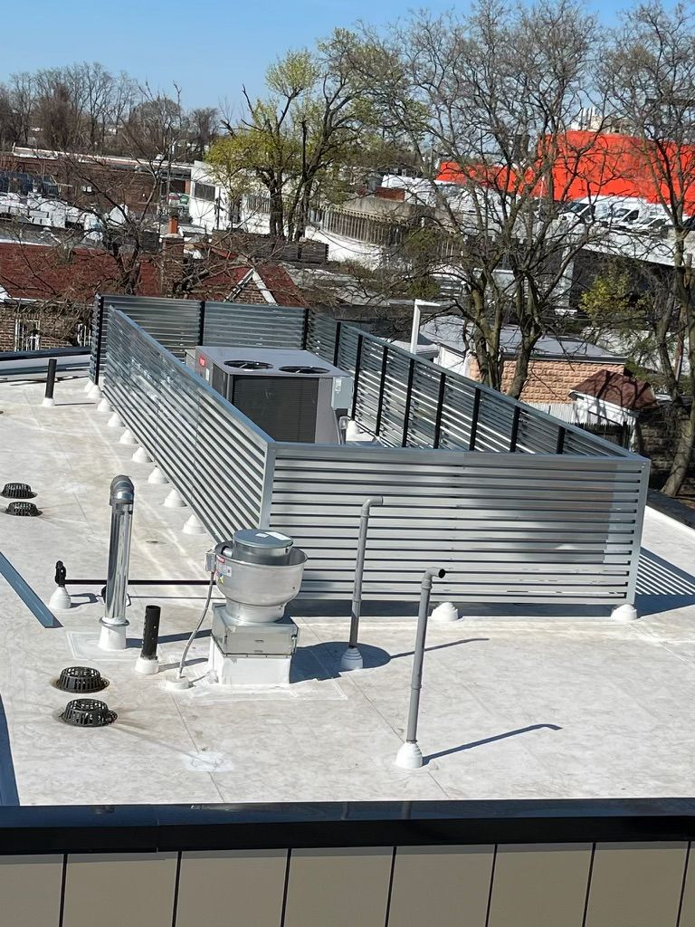 The roof of a building with a fence around it