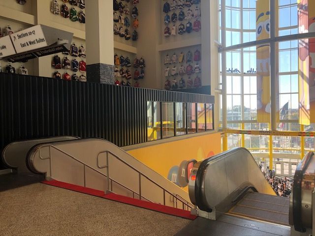 An escalator is going up and down in a large building