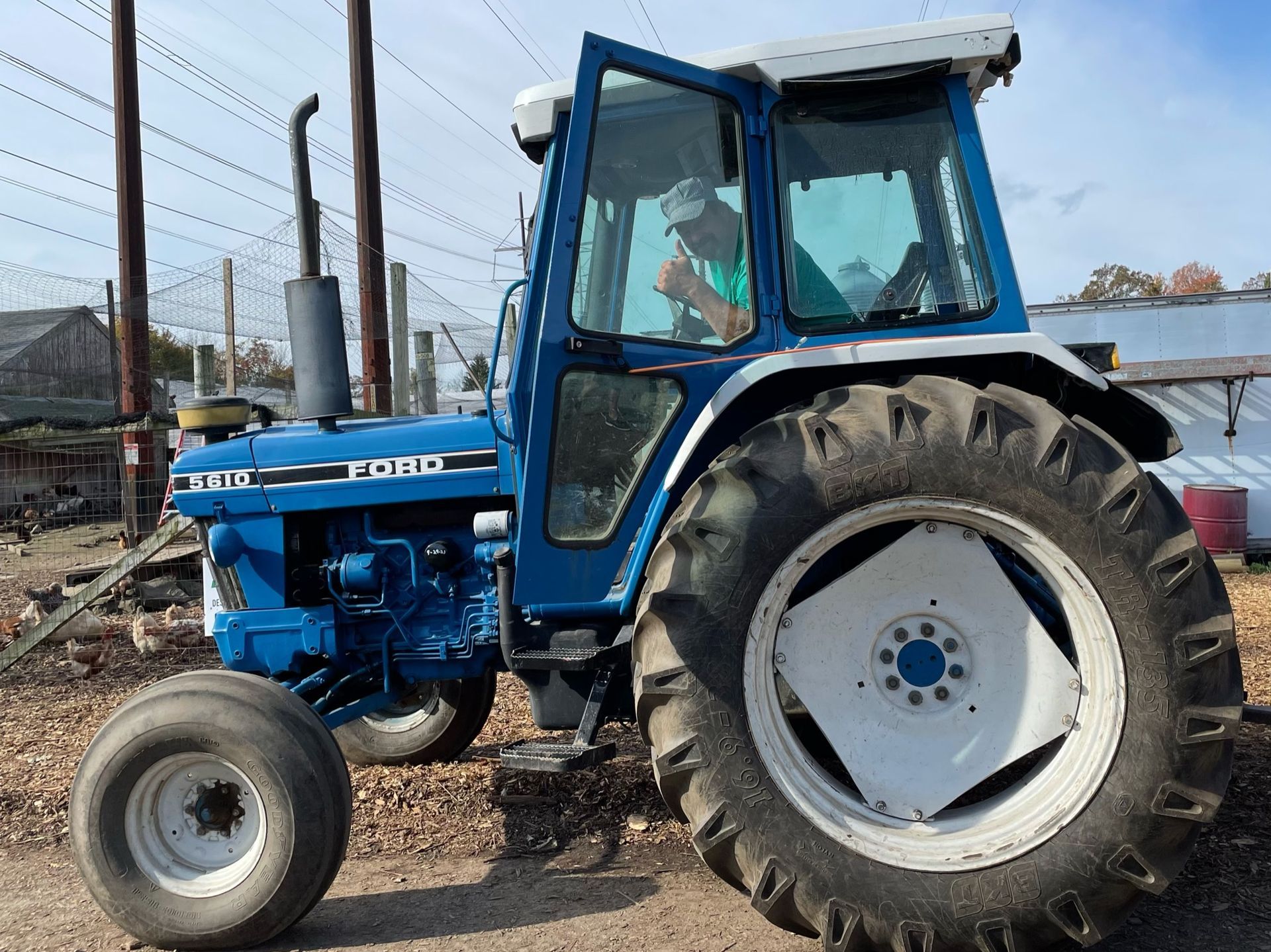 A bunch of potted flowers and pumpkins with a sign that says fall flowers