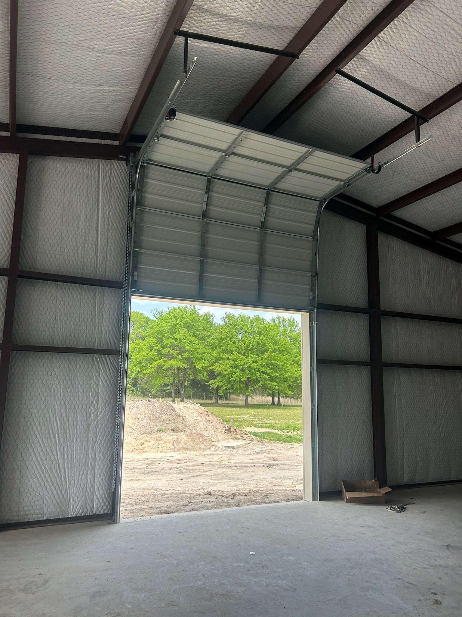 A wooden fence with trees in the background and shadows on it