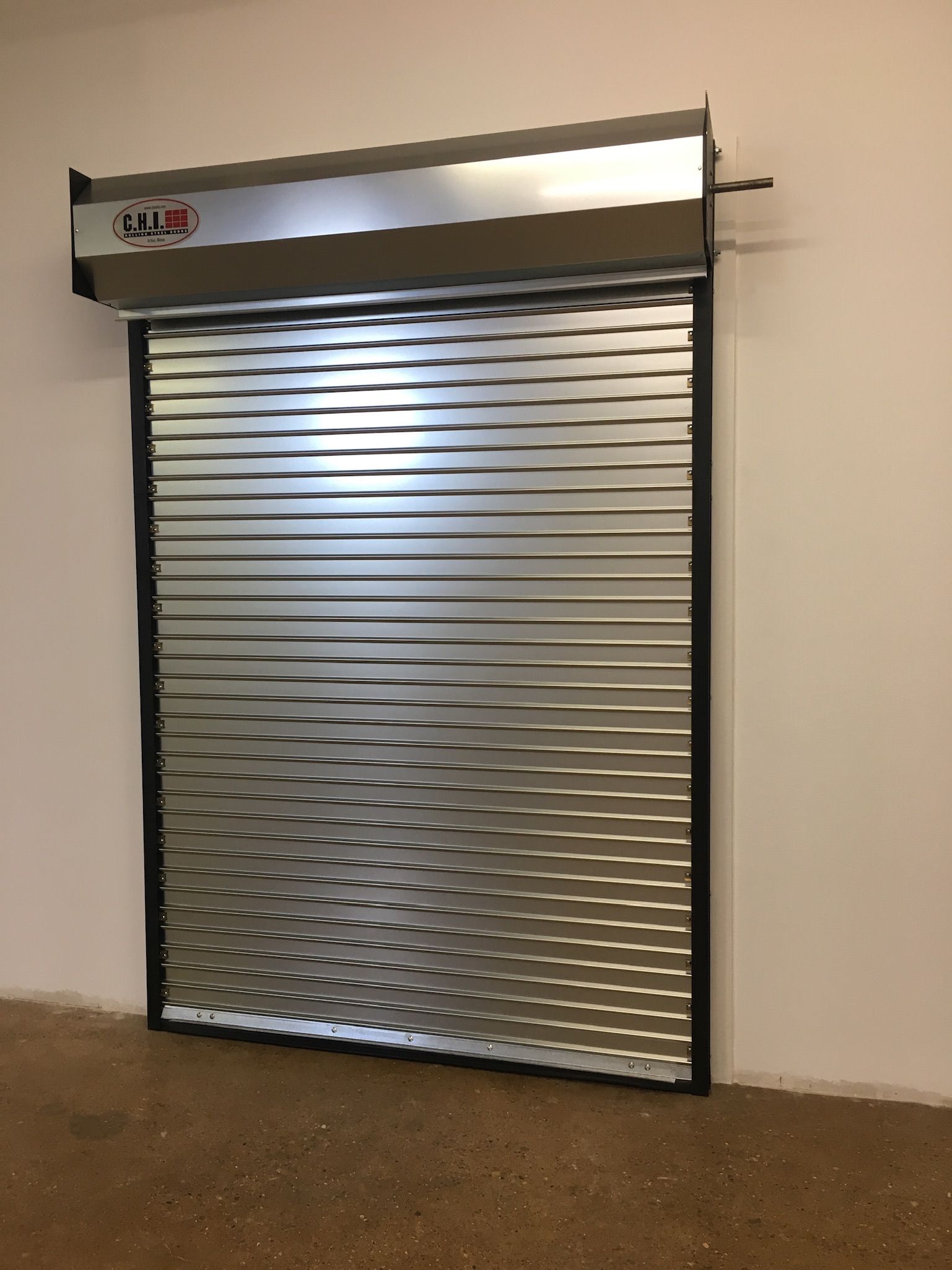 A stainless steel garage door with the word mini on it