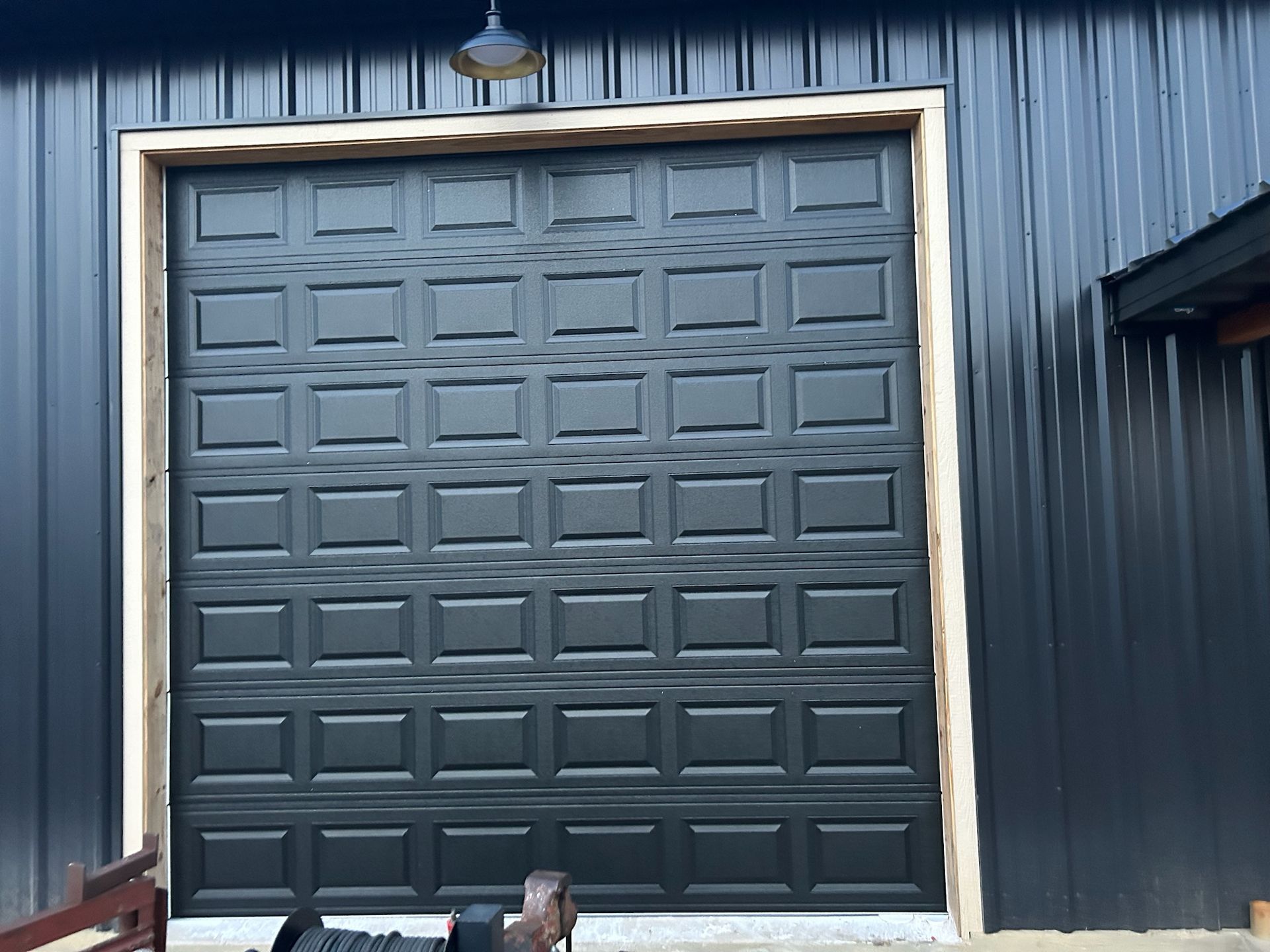 A black garage door on a black building