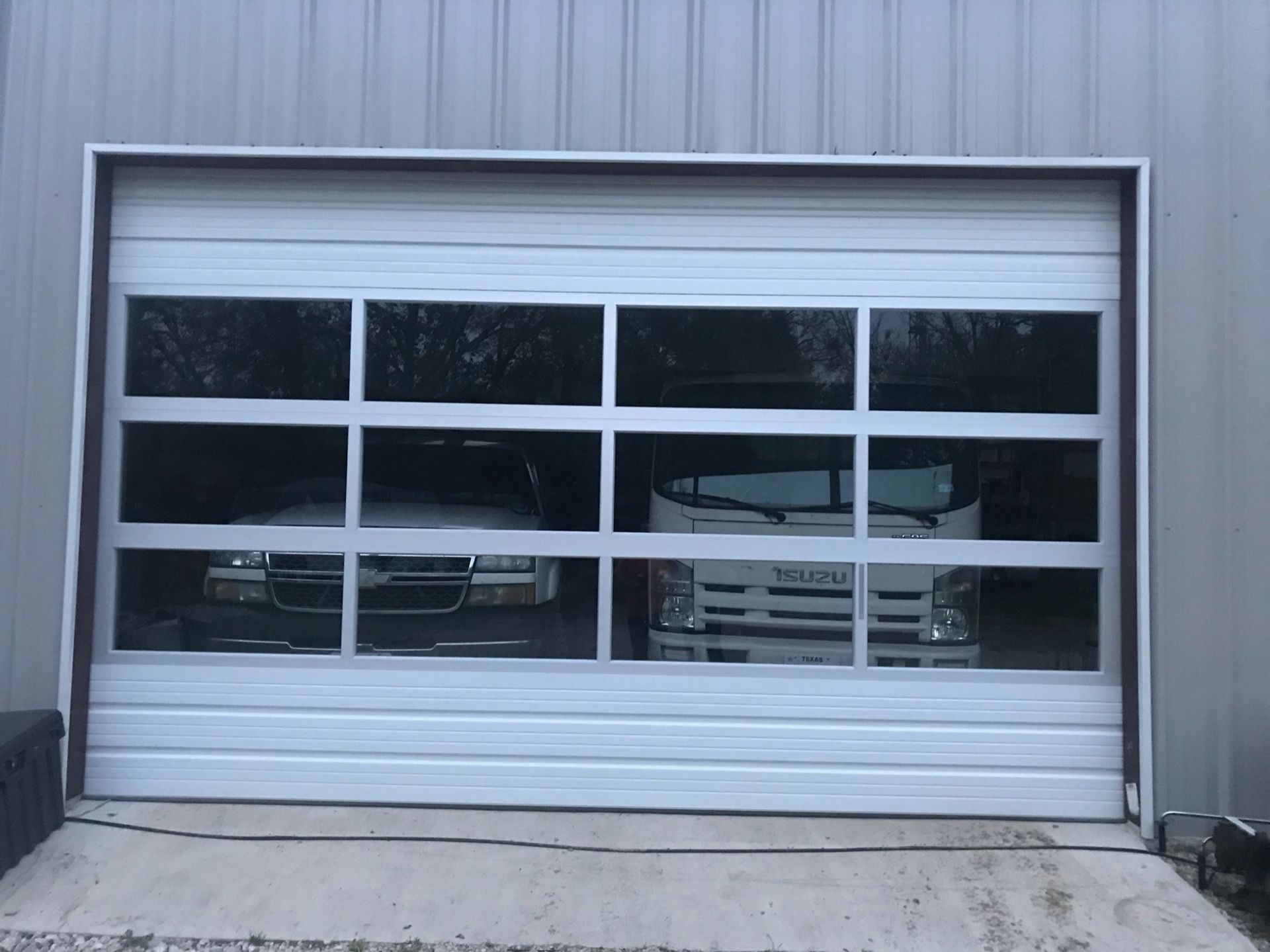 A garage door with a lot of windows and a truck parked in it.