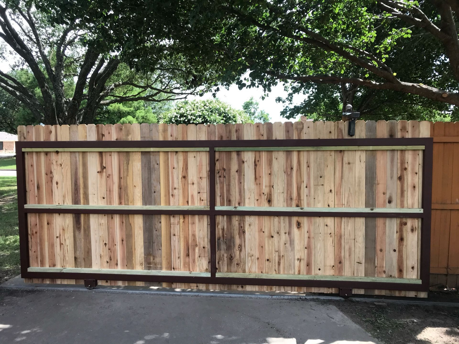 A wooden fence with trees in the background