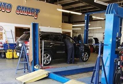 A man is working on a car in a garage.